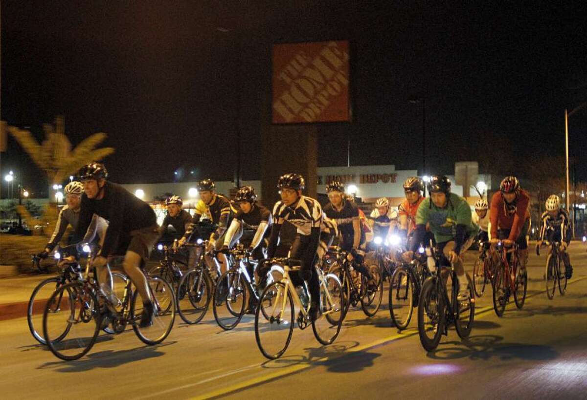 Don Ward, second from left, organizer of WolfPack, leads a group of cyclists on a night ride through the streets of Los Angeles in 2012.