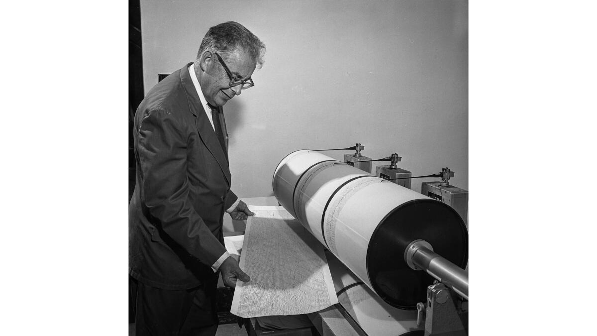 October 1964: Charles Richter studies seismograph log upon which earth movements are recorded.