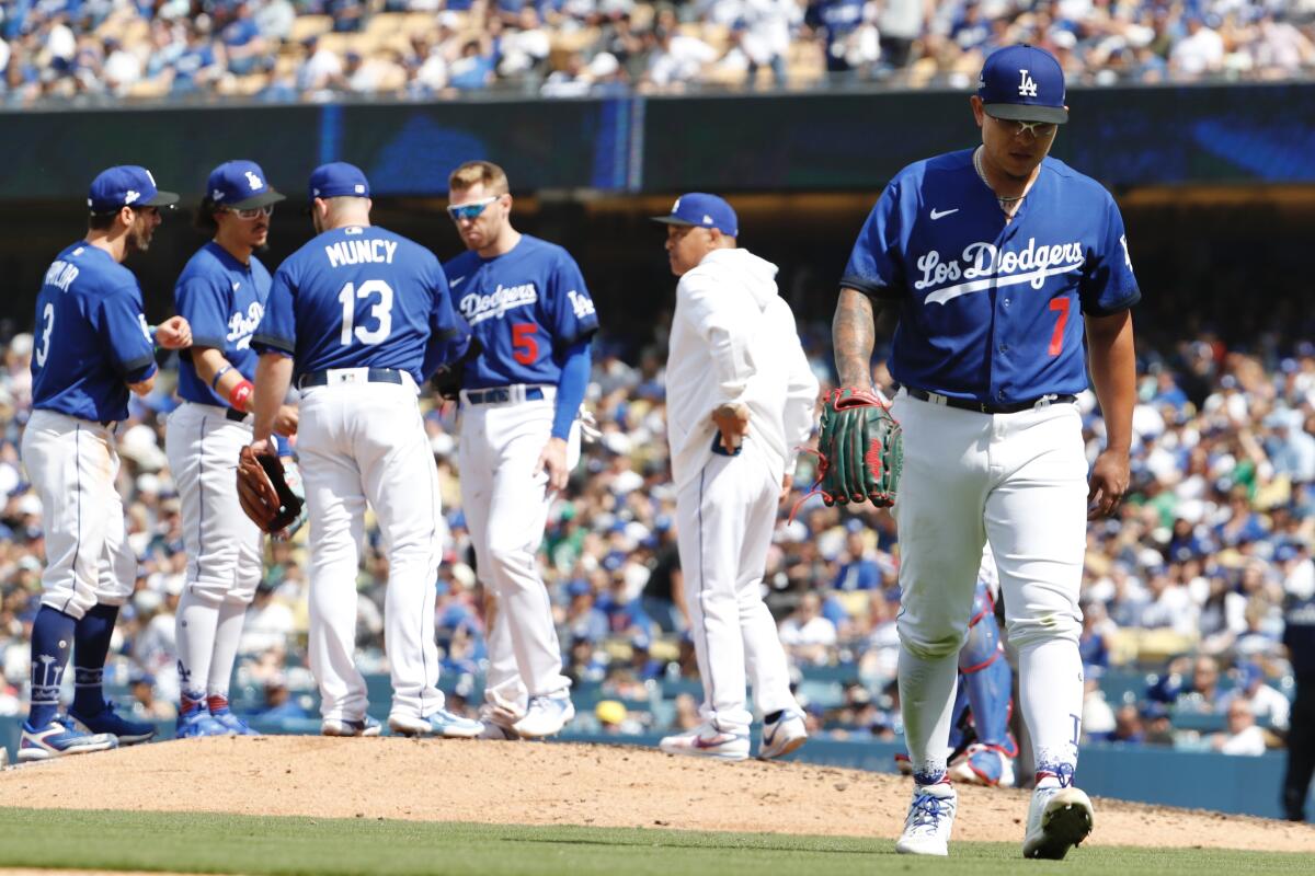 Dodgers pitcher Julio Urías walks to dugout after being pulled during a loss to the Chicago Cubs.