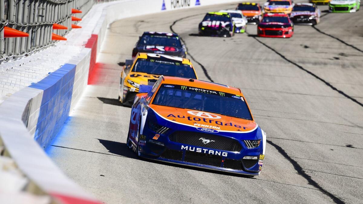 Brad Keselowski leads a row of cars as they come through the front stretch during a Monster Energy NASCAR Cup Series auto race at Atlanta Motor Speedway on Feb. 24 in Hampton, Ga. Keselowski won the race.
