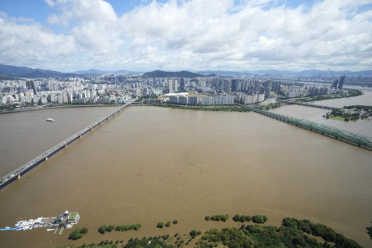 Swollen Han River with Seoul cityscape in background
