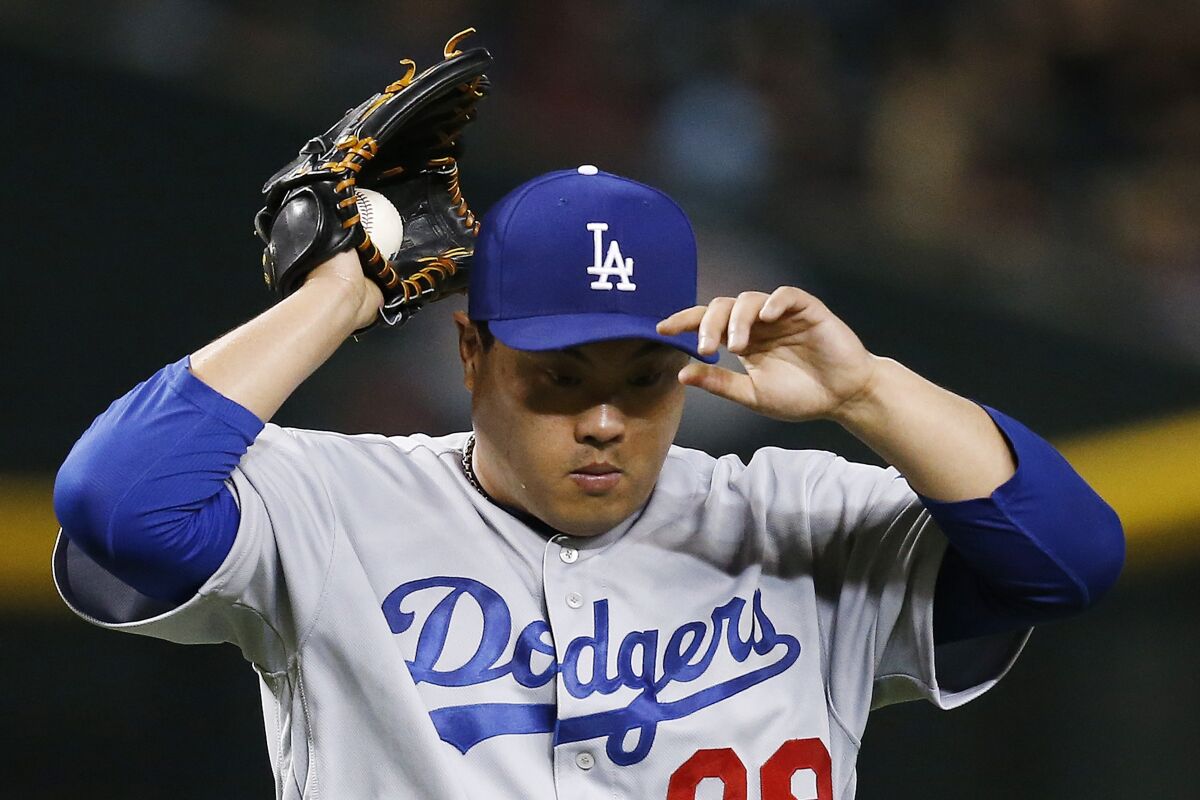 Dodgers starting pitcher Hyun-Jin Ryu pauses on the mound.