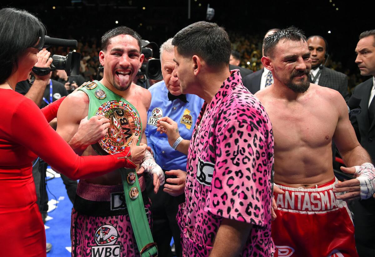 Danny Garcia celebrates with the WBC welterweight title belt draped over his shoulder after defeating Robert Guerrero, at right, by unanimous decision on Saturday night at Staples Center.