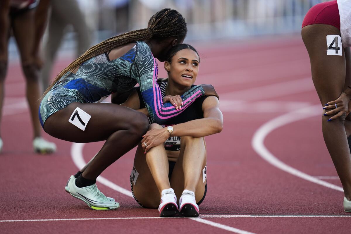 Sydney McLaughlin-Levrone is congratulated by third-place finisher Talitha Diggs after winning the women's 400 meters.