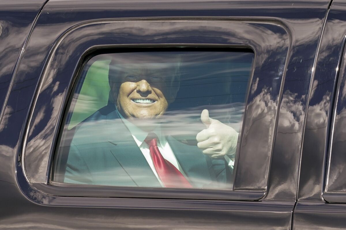 President Trump gives a thumbs-up in his limo.