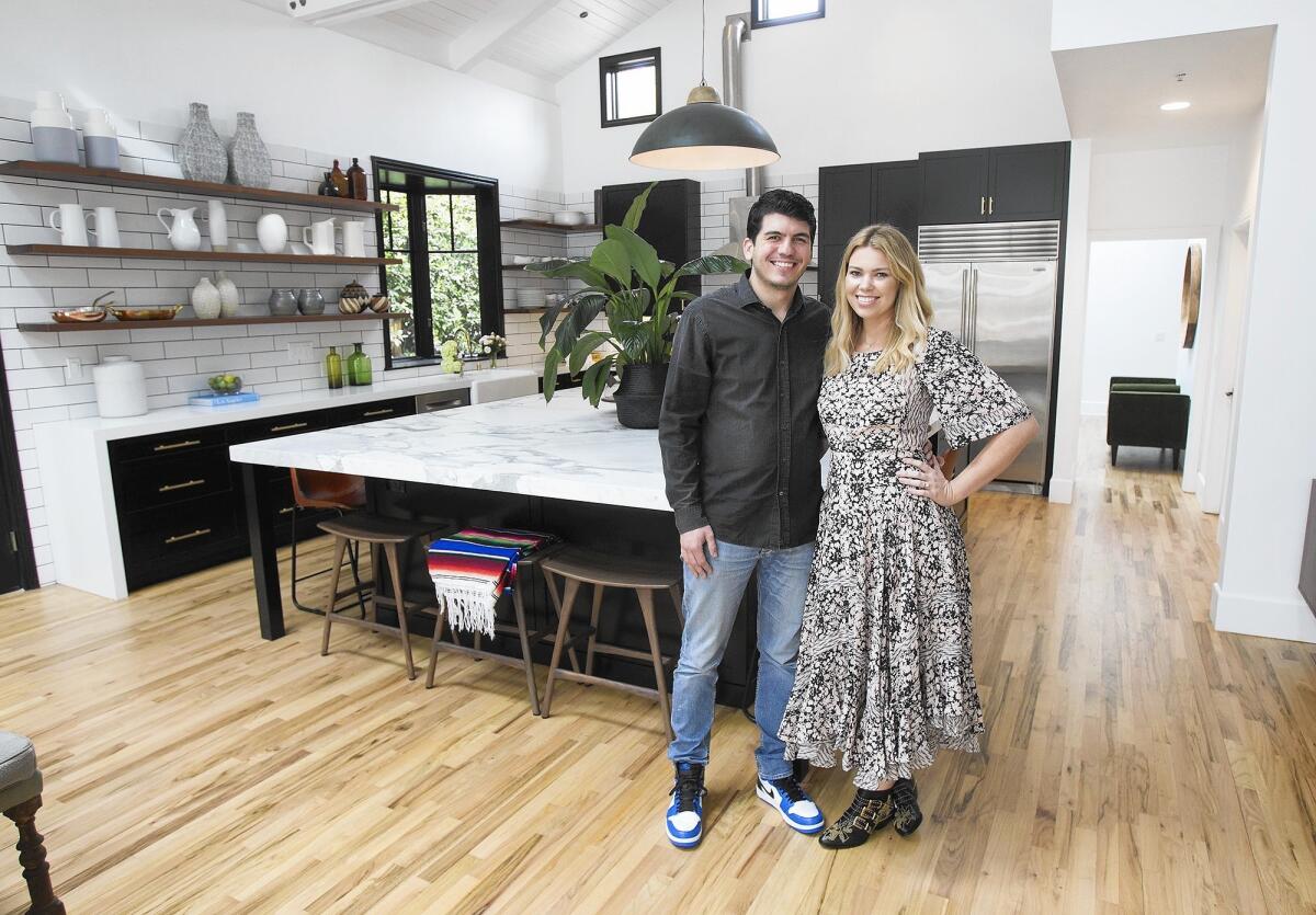 Shannon Wilkins, right, is owner and designer of Prairie Home Staging and Design. She was previously a fashion stylist in L.A. She currently offers services like model home staging and property development design. She stands with her husband David, left, in their Newport Beach home.