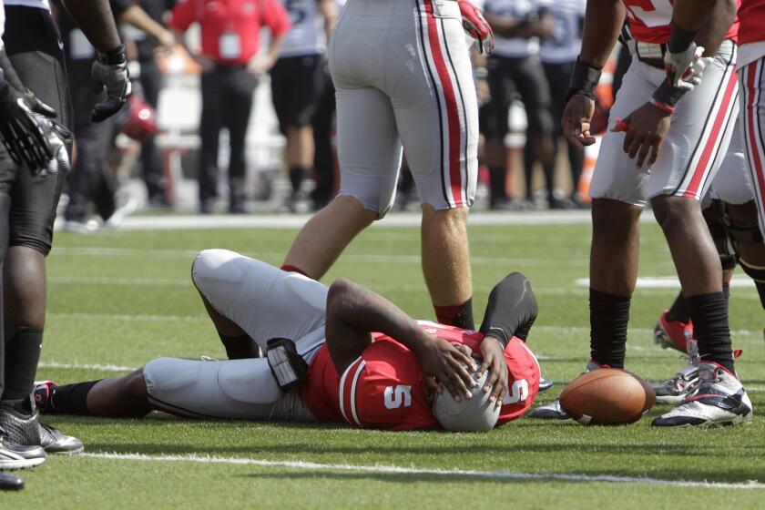 Ohio State quarterback Braxton Miller lies on the field after injuring his knee against San Diego State on Saturday.