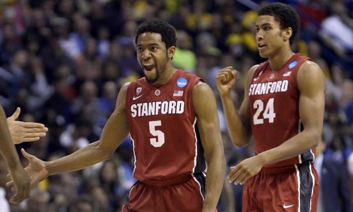 Stanford's Chasson Randle, left, and Josh Huestis celebrate during the second half of their 60-57 upset win over Kansas in the third round of the NCAA tournament Sunday.
