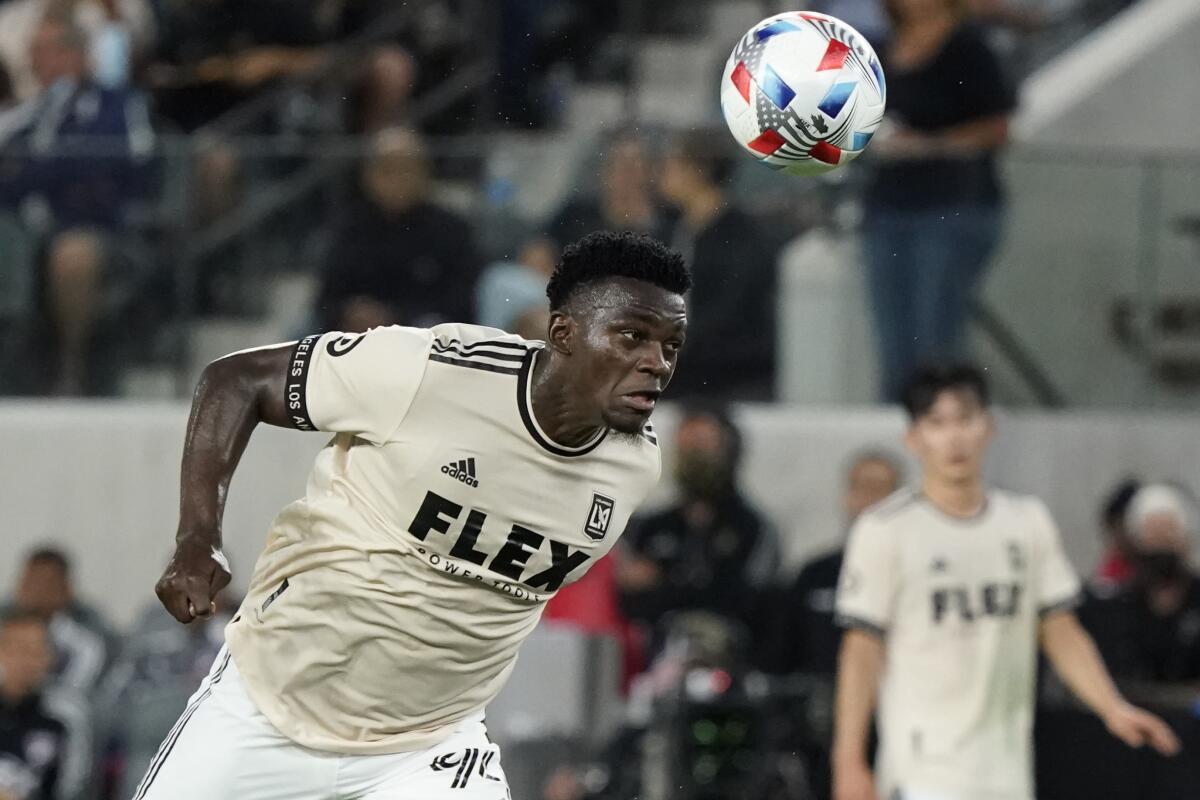 LAFC defender Jesus Murillo heads the ball 