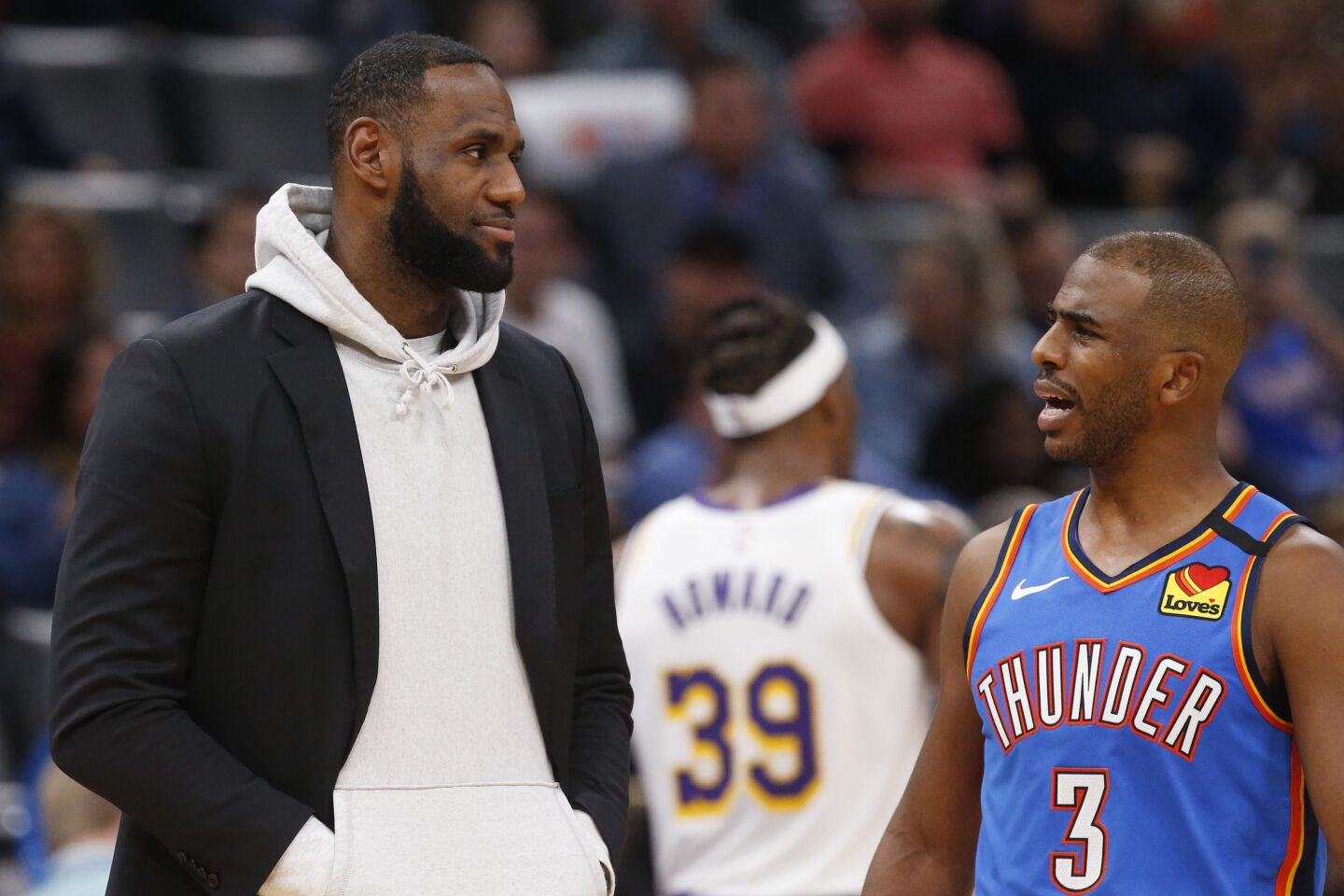 LeBron James and Chris Paul talk during a timeout in the second half of a game Jan. 11 at Chesapeake Energy Arena.