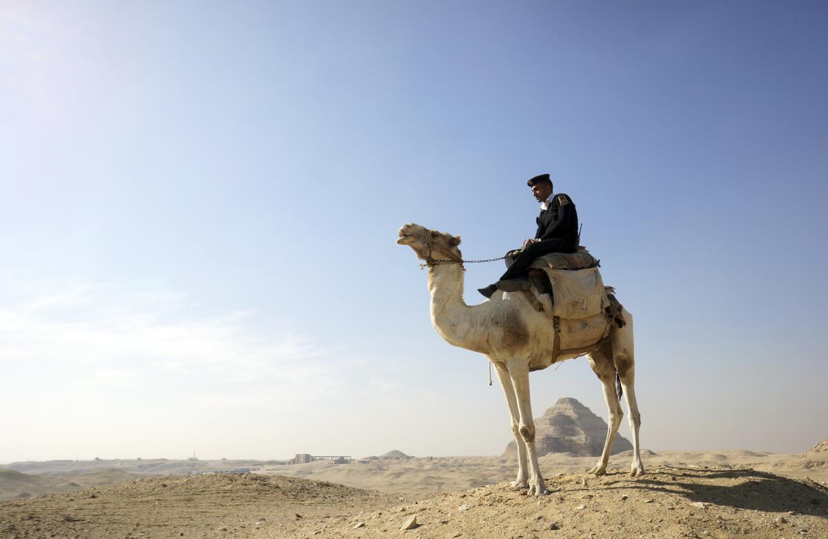 A policeman secures the desert historical site in Saqqara, Egypt.