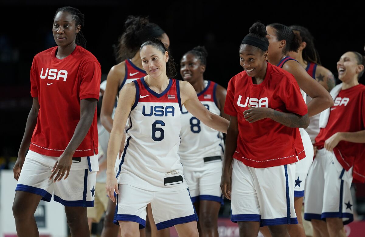 United States' Sue Bird (6) and teammates celebrate after their win in the women's basketball semifinal game against Serbia at the 2020 Summer Olympics, Friday, Aug. 6, 2021, in Saitama, Japan. (AP Photo/Charlie Neibergall)