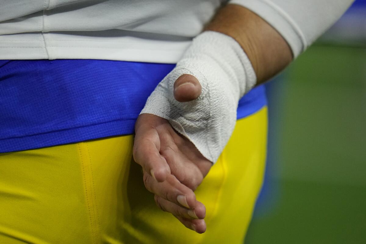 Rams quarterback Matthew Stafford wears a bandage on his throwing hand  after injuring his thumb against the Cowboys
