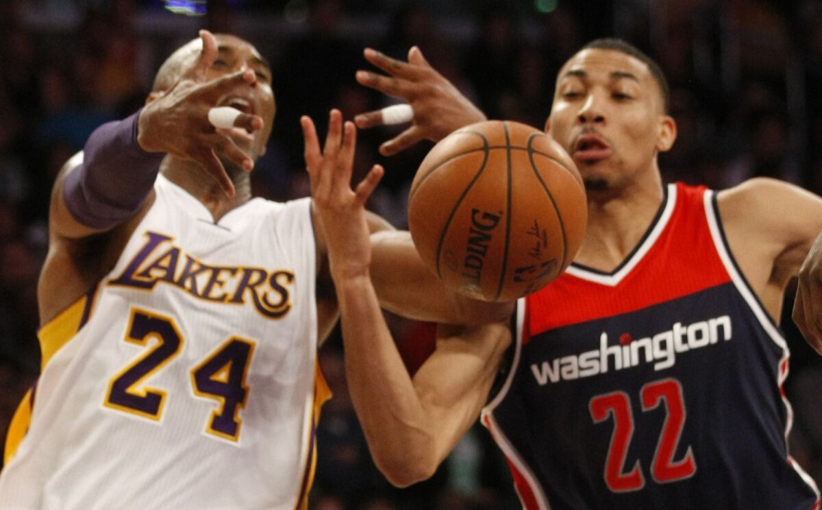 Lakers forward Kobe Bryant loses control of the ball against the defense of Wizards forward Otto Porter Jr.