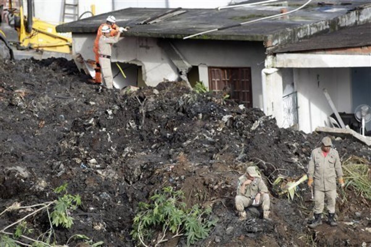 Firefighters search for victims in a landslide at the Morro do Bumba area of the Niteroi neighborhood, in Rio de Janeiro, Thursday, April 8, 2010. A top Rio de Janeiro state security official says at least 200 people have been buried in the latest landslide to hit the area. (AP Photo/Felipe Dana)