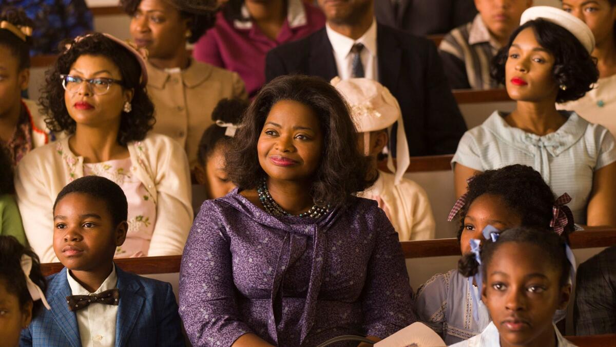 Taraji P. Henson, background left, Octavia Spencer, center, and Janelle Monae, background right, in a scene from "Hidden Figures."