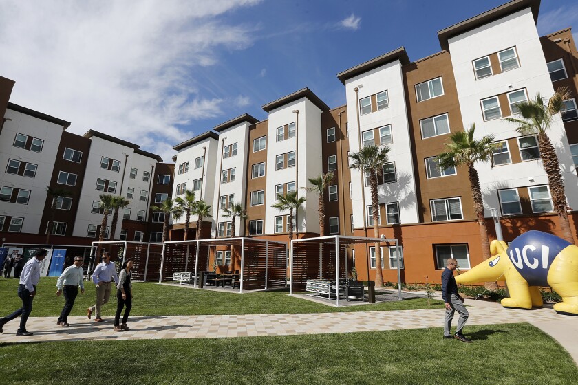 Guests go on a tour of UC Irvine's new Plaza Verde student residence hall during a grand-opening event Wednesday.