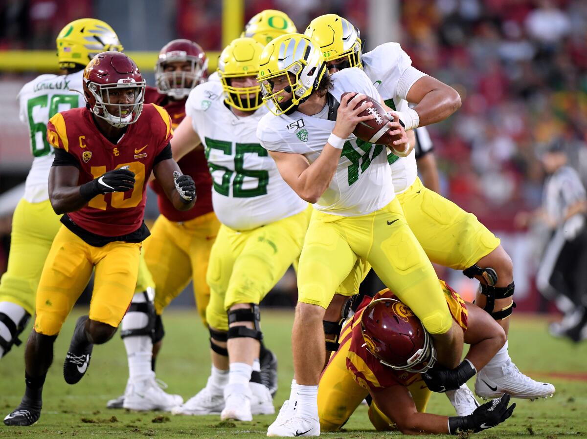 USC's Jay Tufele has a hold on Oregon's Justin Herbert on Nov. 2 at the Coliseum.