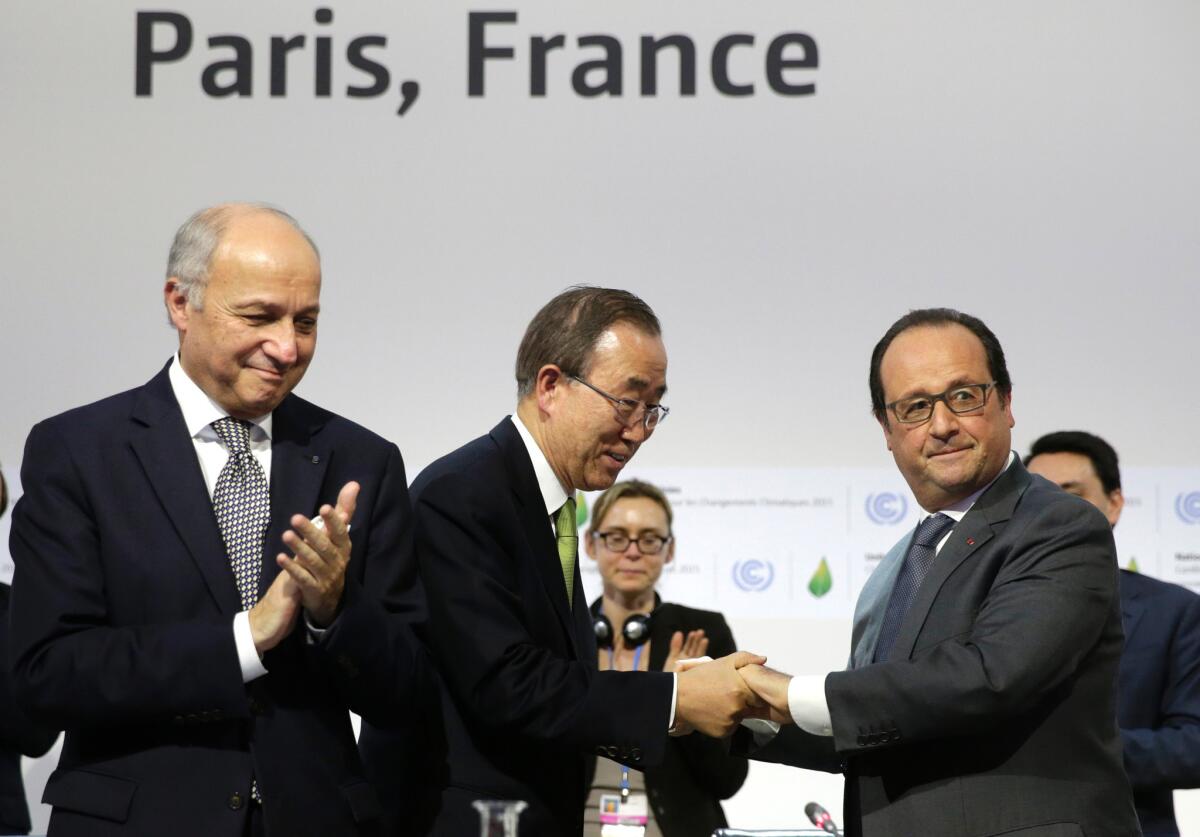 French Foreign Minister Laurent Fabius, left, U.N. Secretary-General Ban Ki-moon, center, and French President Francois Hollande at the final session of the climate change conference Paris, which finally secured a long-sought international agreement.