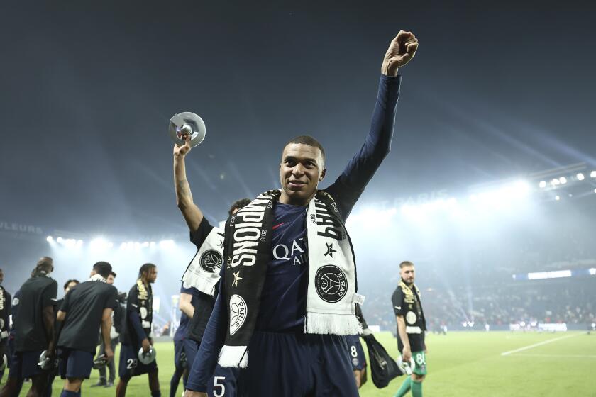 PSG's Kylian Mbappe celebrates PSG's French League One title after the French League One soccer match between Paris Saint-Germain and Toulouse at the Parc des Princes stadium in Paris, Sunday, May 12, 2024. (Franck Fife, Pool via AP)