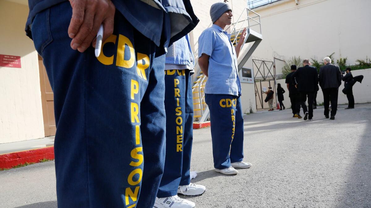 Inmates at San Quentin greet visitors arriving for graduation ceremonies for the Last Mile Works program.