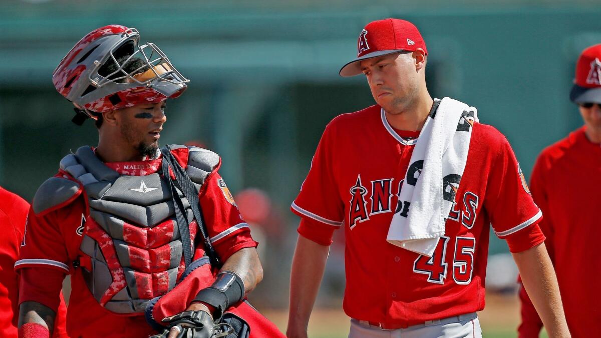 Angels pitcher Tyler Skaggs talks with catcher Martin Maldonado after warming up in the bullpen prior to a spring training game against the Chicago White Sox on March 4.