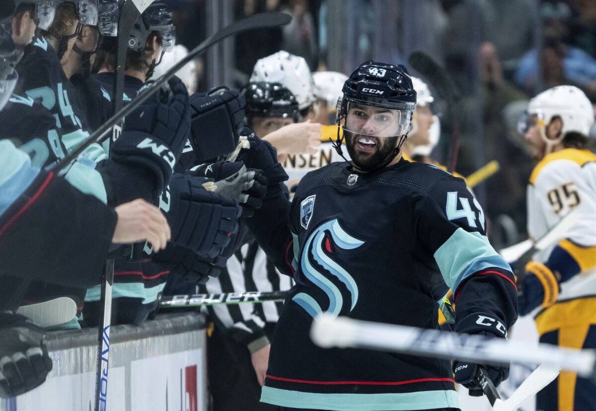 Seattle Kraken forward Colin Blackwell is congratulated by teammates after scoring a shorthanded goal during the third period of the team's NHL hockey game against the Nashville Predators, Wednesday, March 2, 2022, in Seattle. The Kraken won 4-3. (AP Photo/Stephen Brashear)
