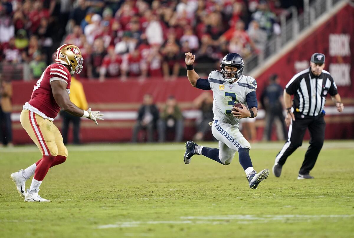 Seahawks quarterback Russell Wilson runs with the ball during a game against the 49ers on Nov. 11 at Levi's Stadium.