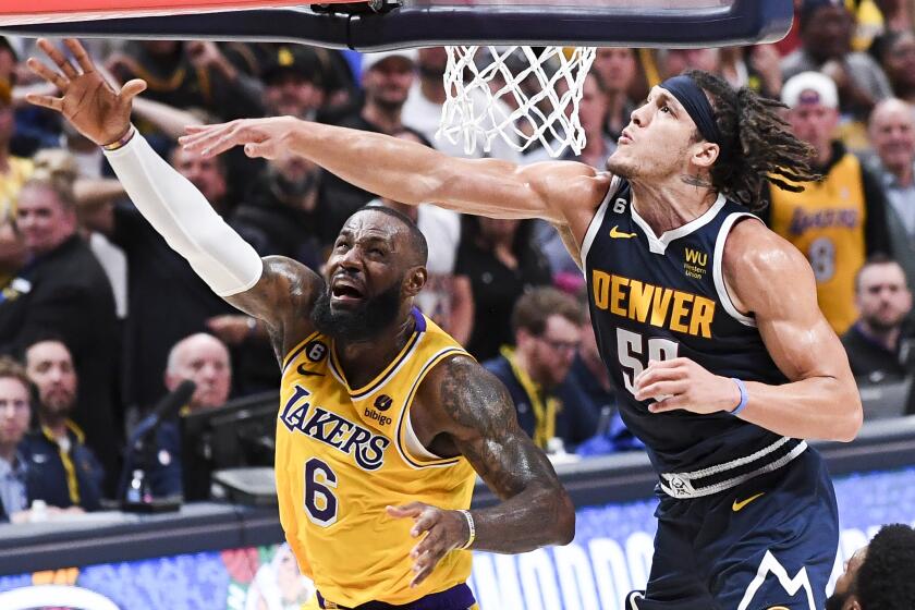 DENVER, CO - MAY 18: Los Angeles Lakers forward LeBron James, left, shoots as Denver Nuggets forward Aaron Gordon.