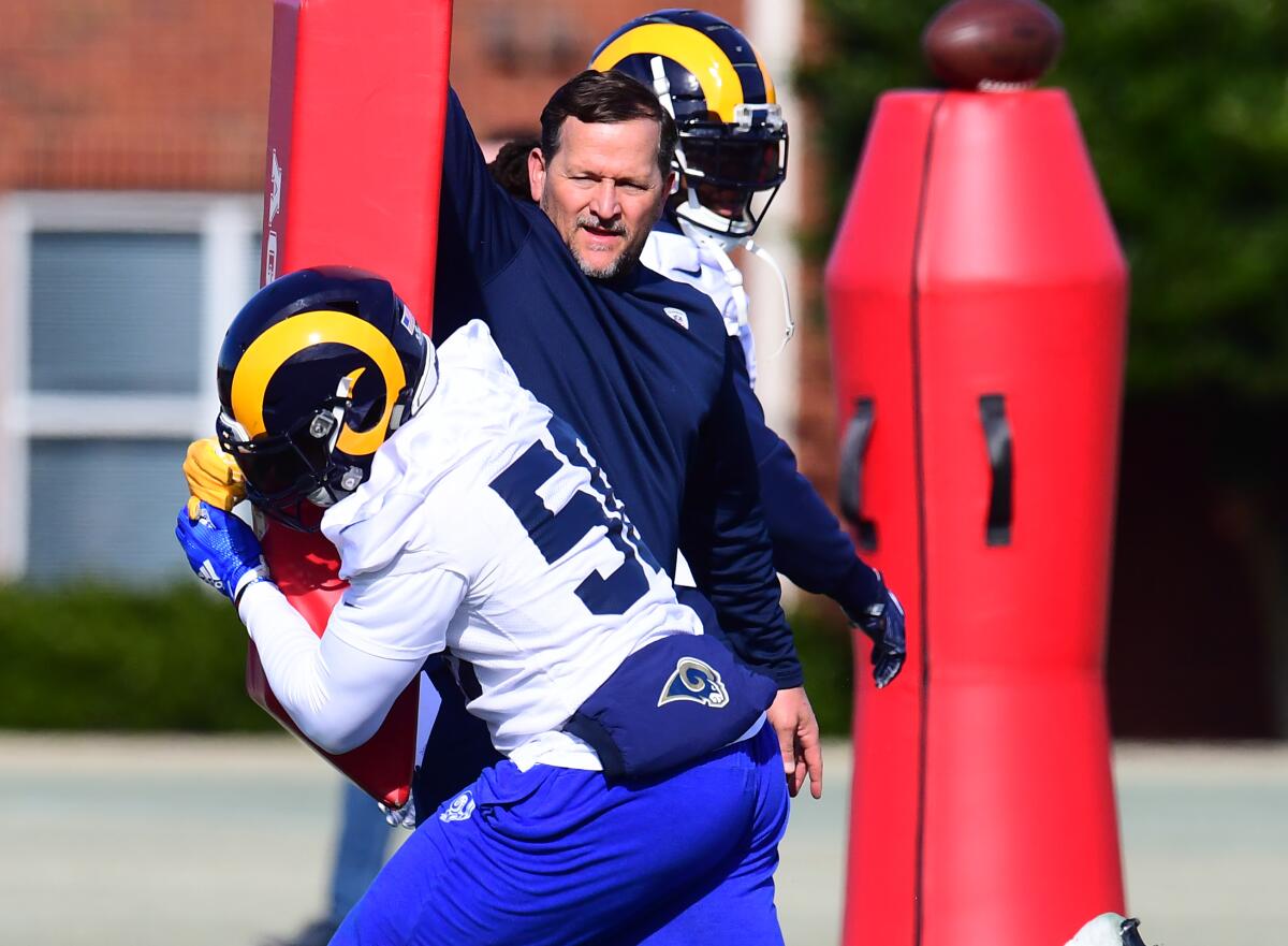 Rams linebacker coach Joe Barry works with Cory Littleton during a practice.