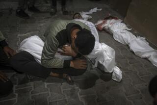A Palestinian youth mourns his relative killed in the Israeli bombardment of the Gaza Strip, at the morgue of the Kuwaiti Hospital in Rafah refugee camp, southern Gaza Strip, early Saturday, April 20, 2024. (AP Photo/Ismael Abu Dayyah)