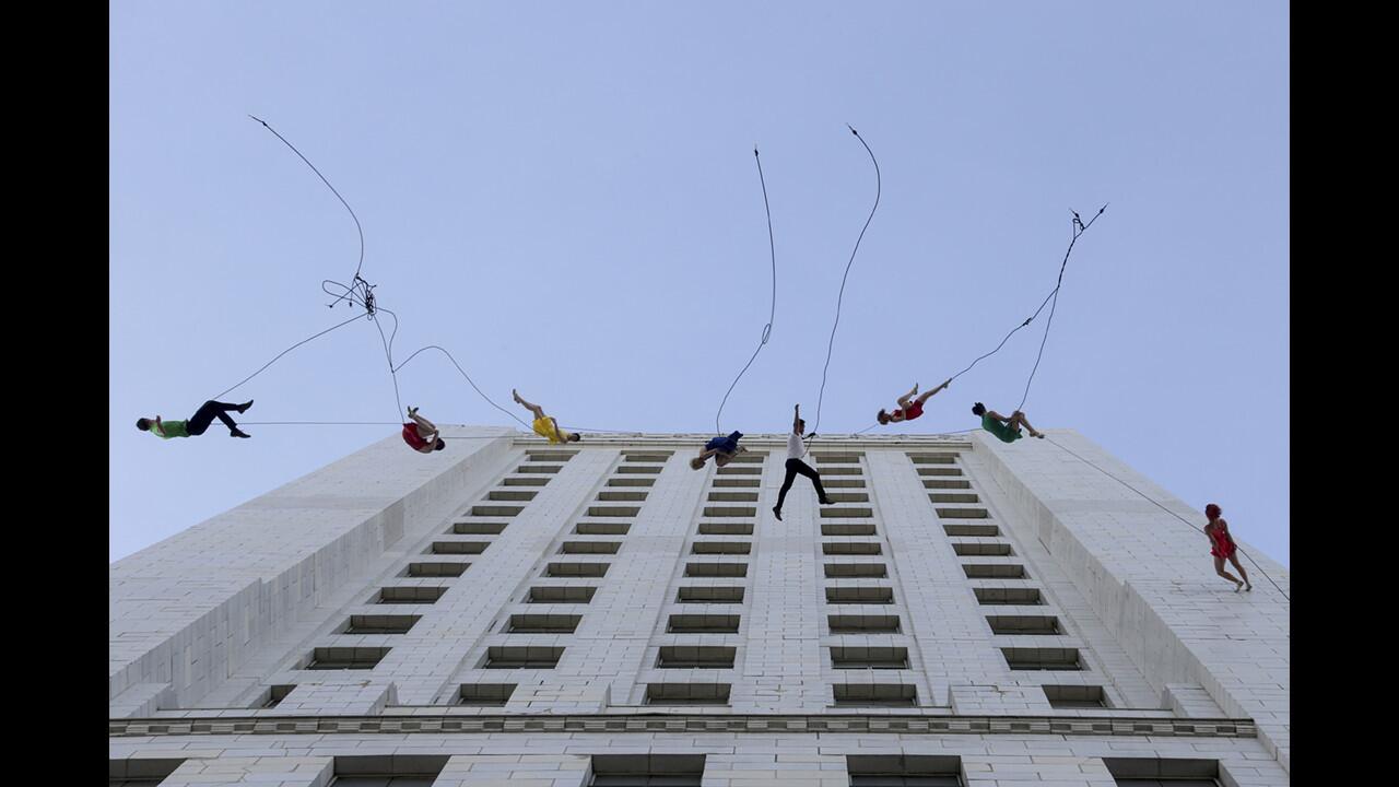 Bandaloop aerial dancers rappel down City Hall and dance across the tower during the "La La Land" Day celebration April 25 honoring the award-winning film and its director, Damien Chazelle.