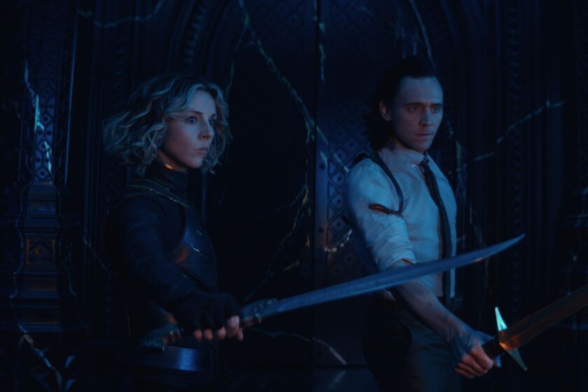 A woman and a man with their swords drawn