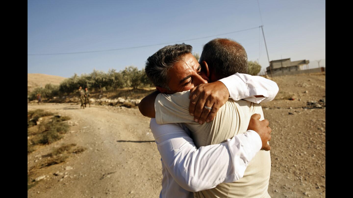 In the village of Faziliya, recently liberated from Islamic State control, Abdul Gafur, 38, embraces his brother Mohammad Abdul Gafur, 40, after not seeing him for more than two years. Peshmerga forces recaptured the village and escorted Abdul to visit his brother.