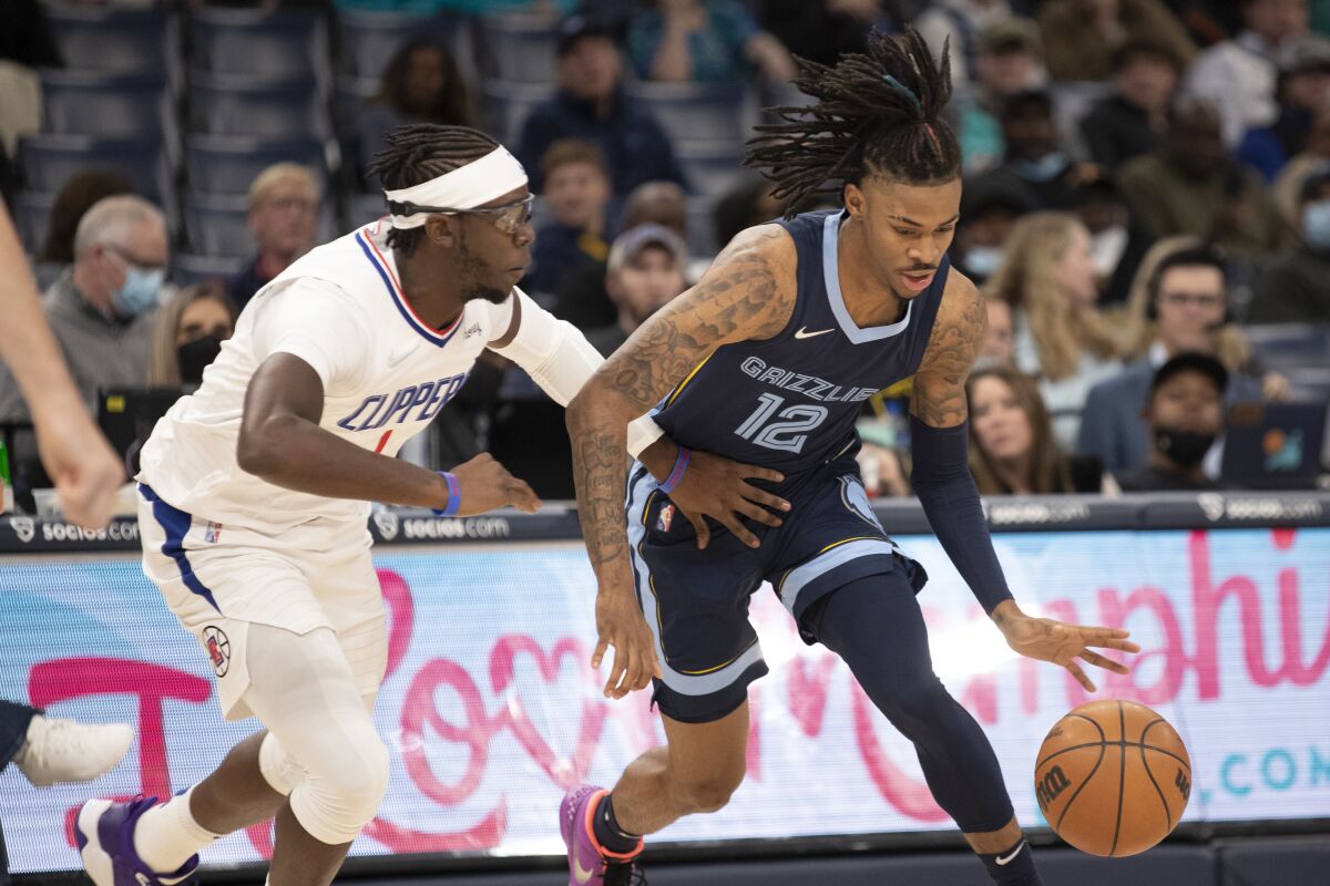 Clippers guard Reggie Jackson defends against Memphis Grizzlies guard Ja Morant.
