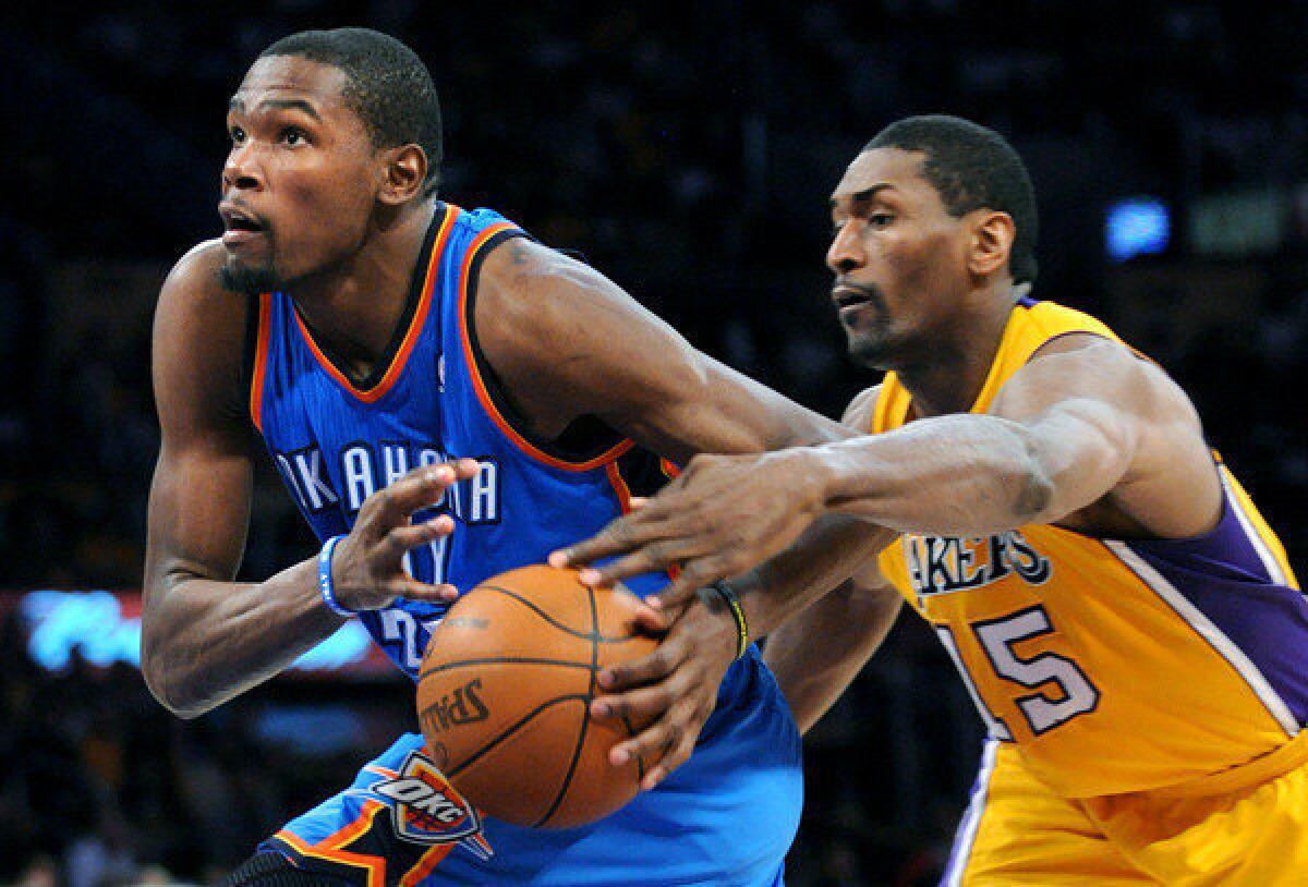 Kevin Durant drives past Metta World Peace during the second half of Game 4.