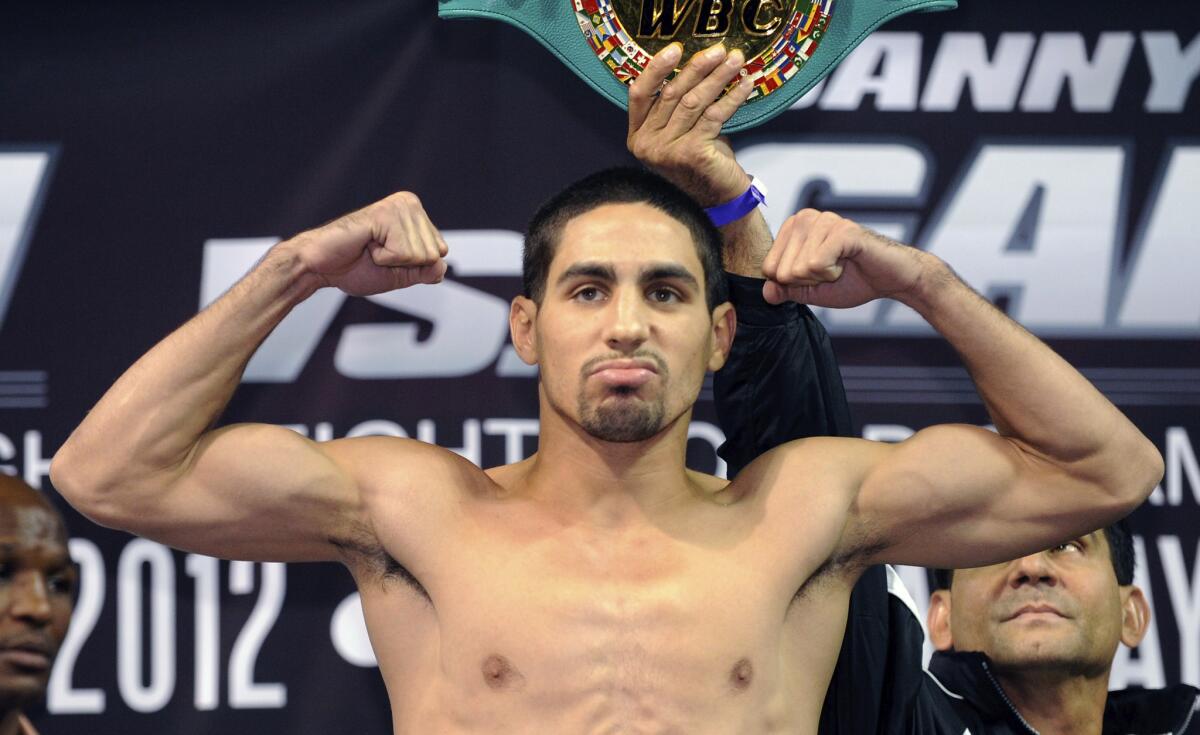 Danny Garcia weighs in for a 2012 bout against Amir Khan.