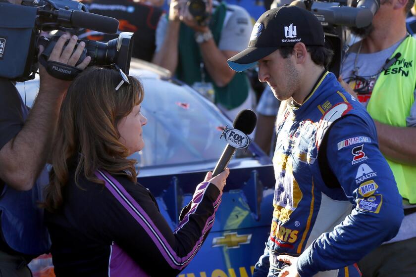 NASCAR driver Chase Elliott is interviewed after clinching the Nationwide Series championship by finishing fifth in the race Saturday at Phoenix International Raceway.