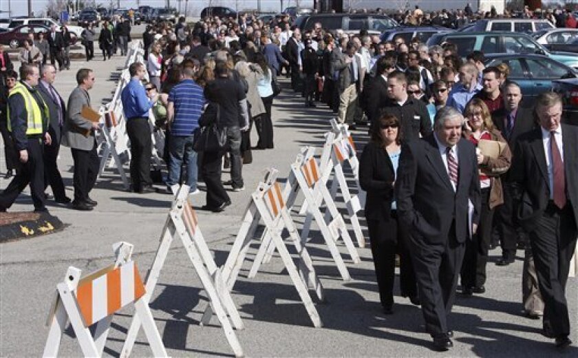 Thousands of unemployed wait in lines for buses to a job fair at the Mall of New Hampshire parking lot in Manchester, N.H., Thursday, April 9, 2009. New jobless claims fell more than expected last week but are stuck at elevated levels, while the number of people continuing to receive unemployment insurance approached 6 million, setting a record for the 10th straight week. (AP Photo/Jim Cole)