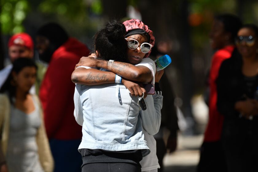 SACRAMENTO, CALIFORNIA - APRIL 3: Two women hug each other at the scene of a mass shooting in Sacramento, Calif., on Sunday, April 3, 2022. Six people are dead and 12 others are injured after a shooting broke out early Sunday morning. Sacramento Police Chief Kathy Lester said there were no suspects in custody yet. The shooting happened in the vicinity of the 1000 block of K Street in downtown Sacramento. (Photo by Jose Carlos Fajardo/MediaNews Group/East Bay Times via Getty Images)