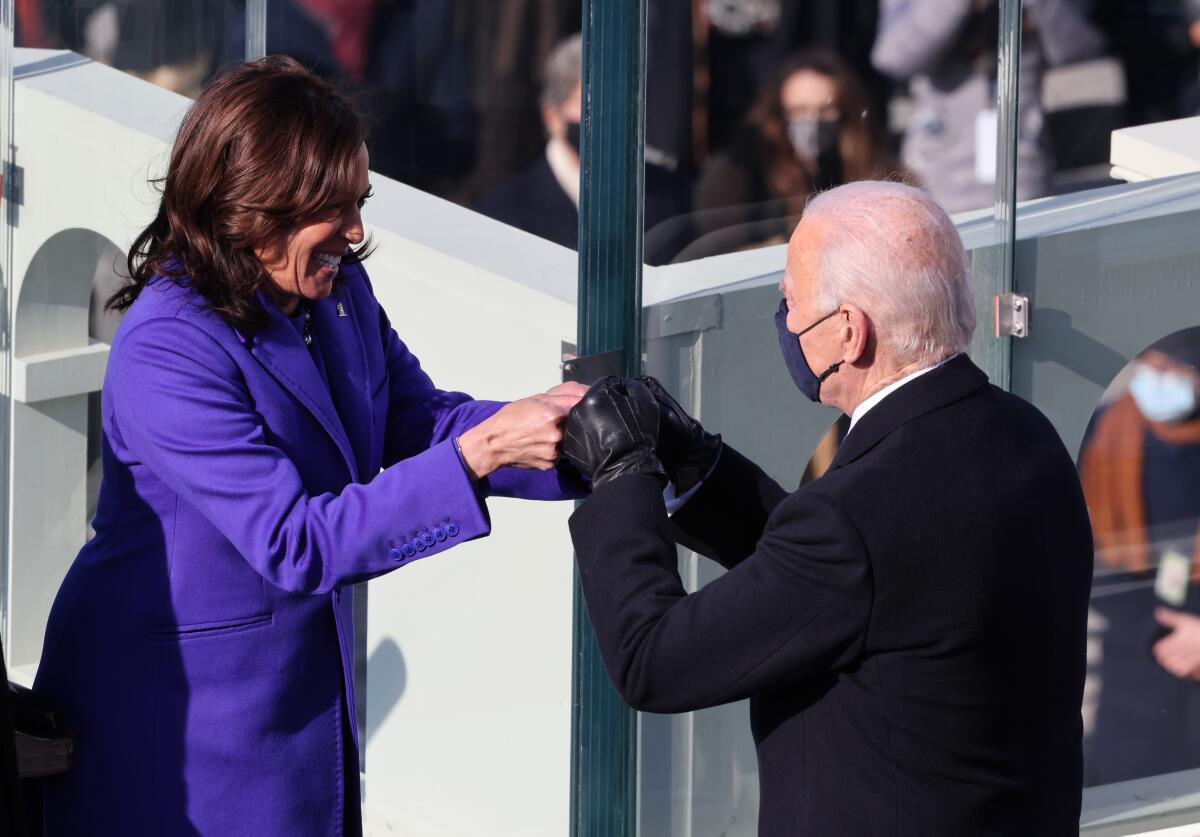 Vice President Kamala Harris and President Joe Biden fist bump during the inauguration