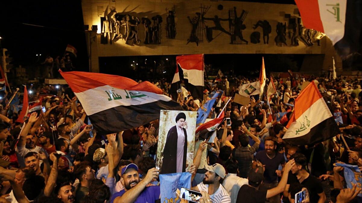 Followers of Shiite cleric Muqtada Sadr, displayed on a poster, celebrate in Tahrir Square, Baghdad, on May 14. Sadr's surprise lead in the Iraqi election poses a challenge to U.S. officials.