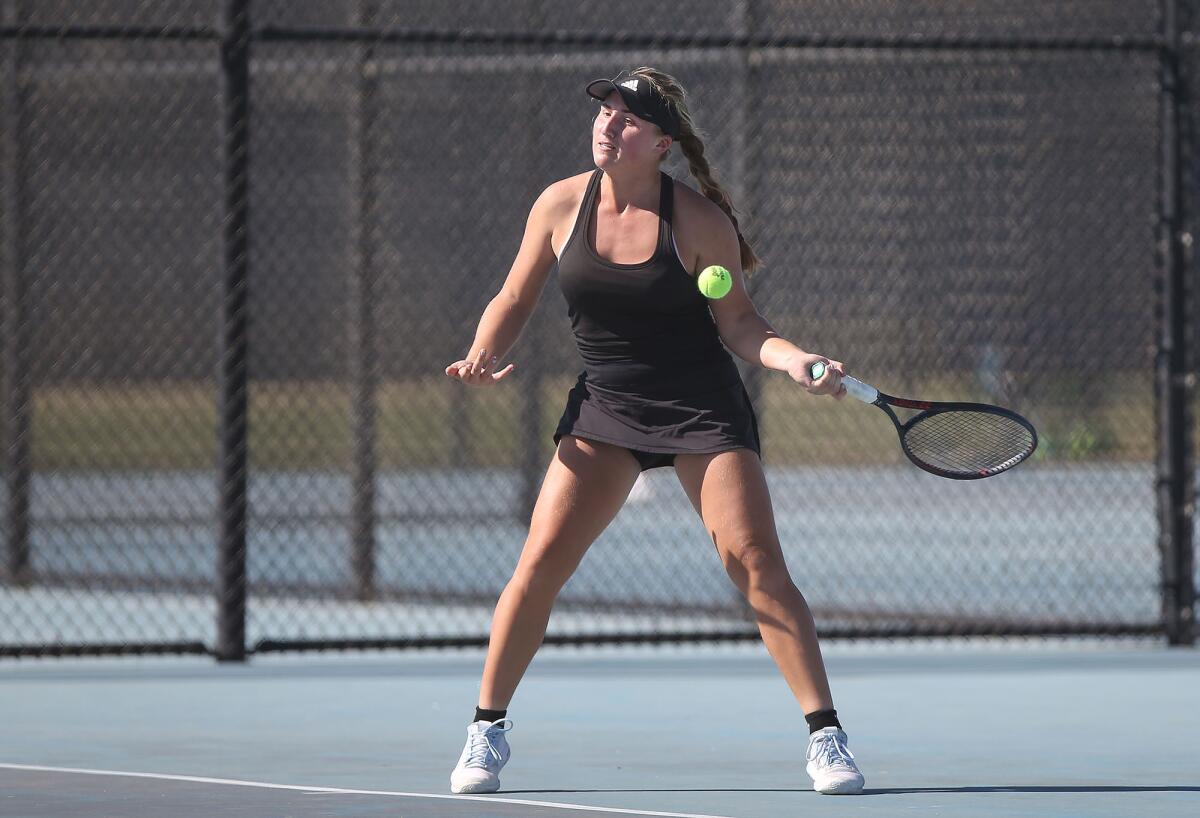 Huntington Beach's Kaytlin Taylor hits a forehand at the baseline against Marina's Makenna Livingston in the singles semifinals of the Wave League tournament on Thursday at Marina High.