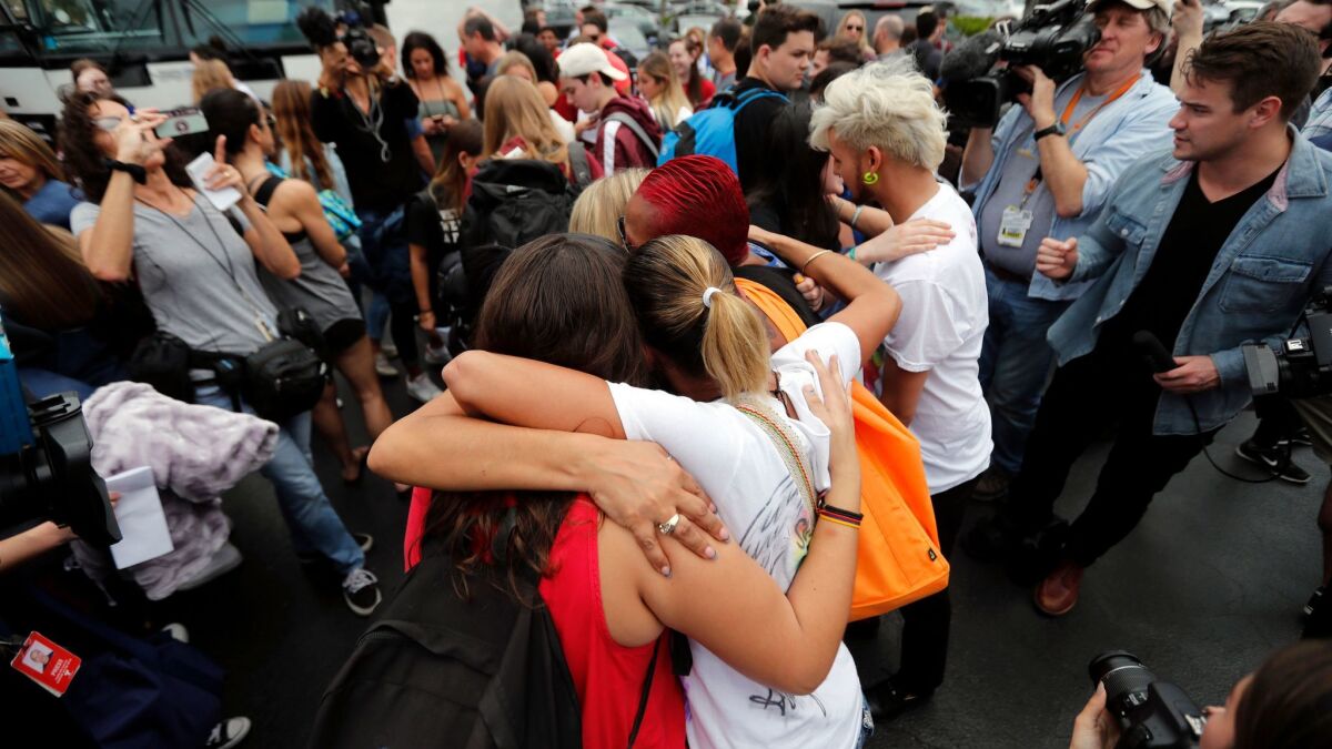Students from Marjory Stoneman Douglas High School hug survivors of the Pulse nightclub shooting before heading to a rally. Florida's House has voted down a motion to take up a bill that would ban assault rifles.