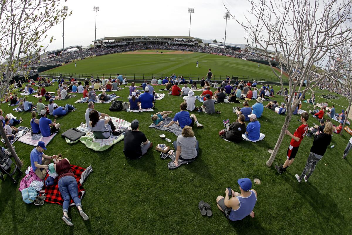 Fans watch from the outfield at Surprise Stadium, the spring home of the Texas Rangers and Kansas City Royals.