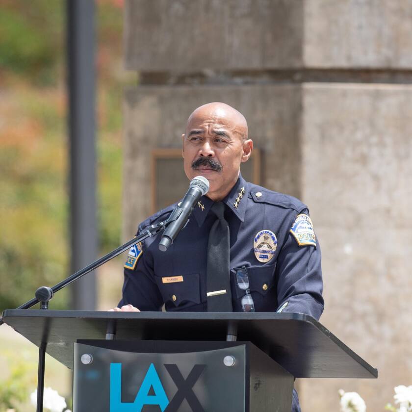 Los Angeles International Airport Police Chief Cecil Rhambo speaks at a lectern