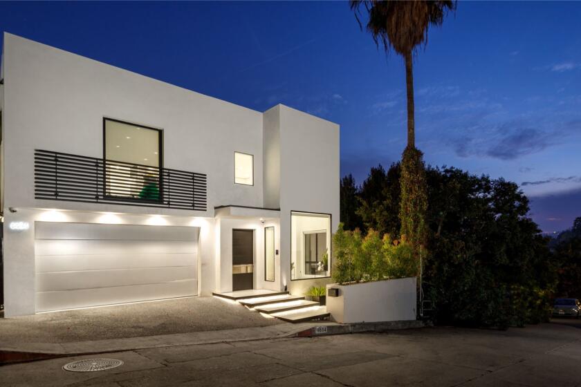 The scenic three-story spot features a whitewashed floor plan with polished slab floors and walls of glass.