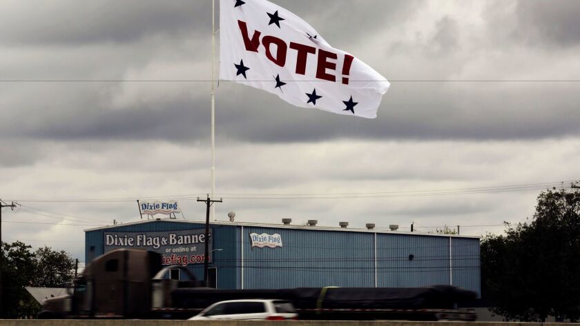 A huge "Vote!" flag waves above Interstate 35 as motorists pass in San Antonio on Nov. 8, 2016.