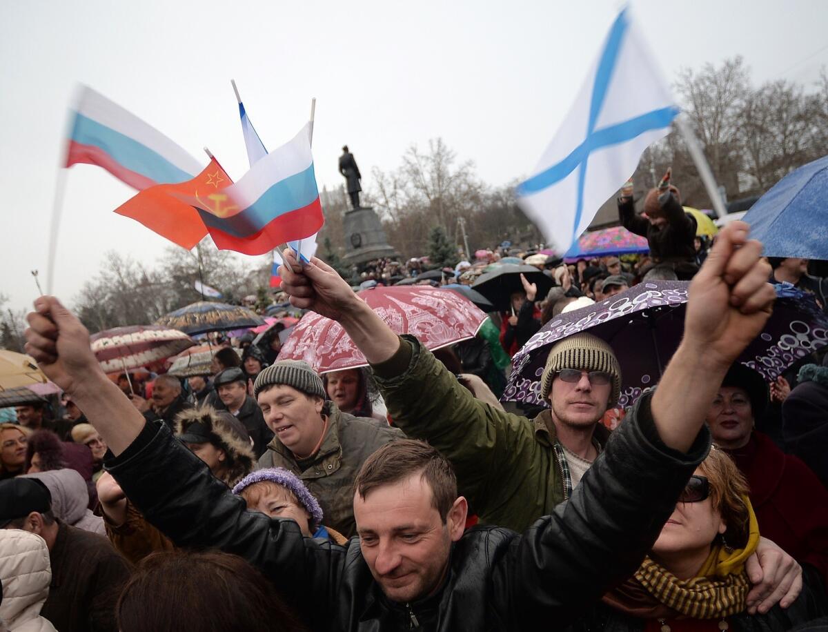 Pro-Russian supporters wave Russian flags during a mass pro-Russian rally in the center of Sevastopol, on Saturday.