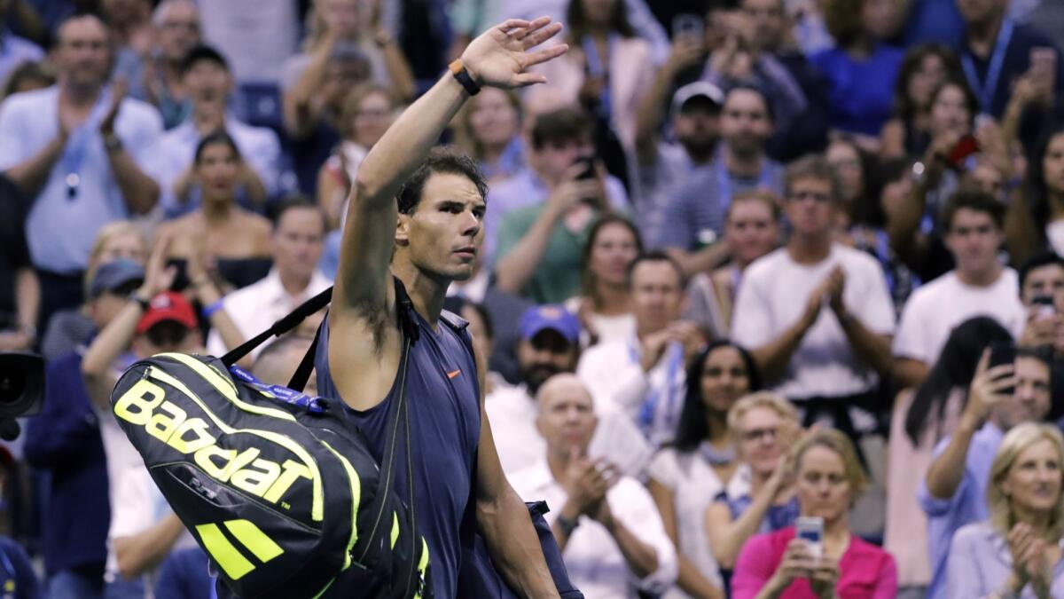 Rafael Nadal, of Spain, waves to fans after retiring from a match against Juan Martin del Potro, of Argentina, during the semifinals of the U.S. Open